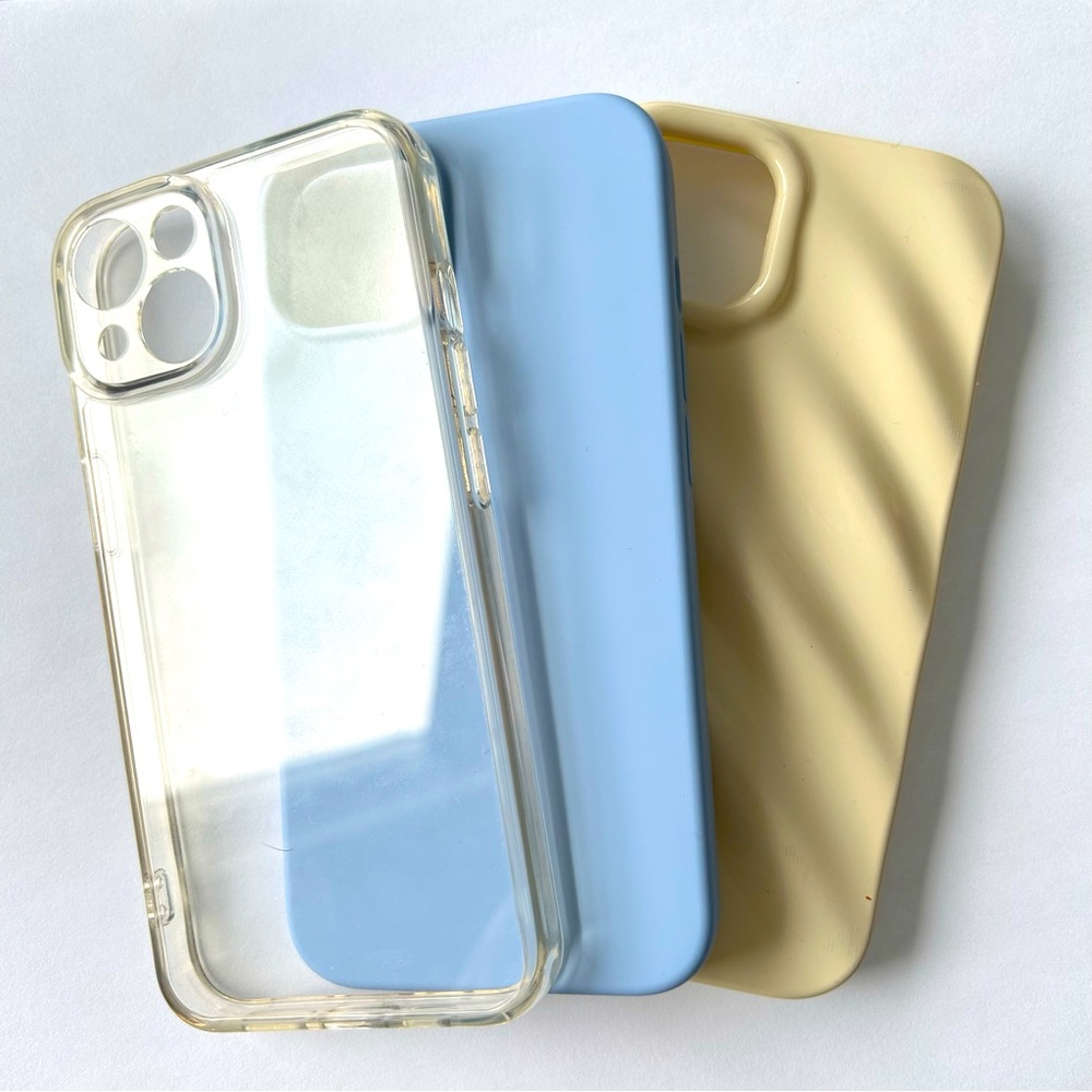 Clear, Blue, and wavy cream iPhone 14 cases